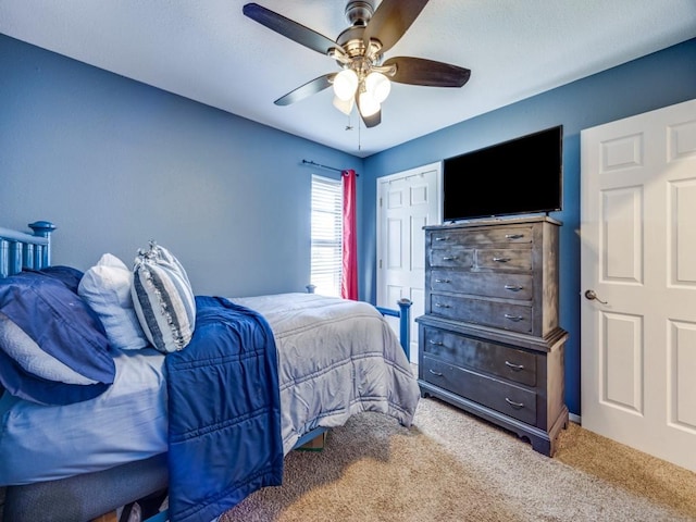 carpeted bedroom with a closet and ceiling fan