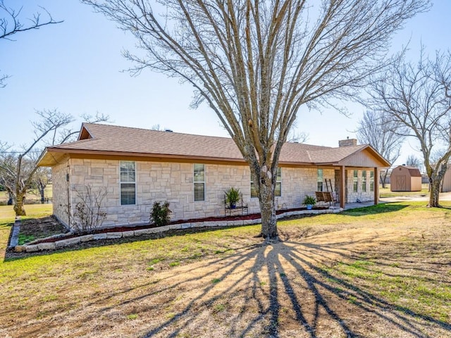 back of property with an outdoor structure, a lawn, a shed, and a chimney