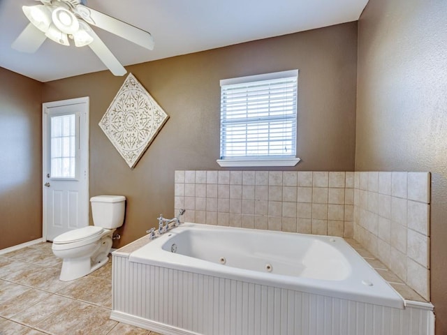 full bath with tile patterned flooring, a jetted tub, and toilet