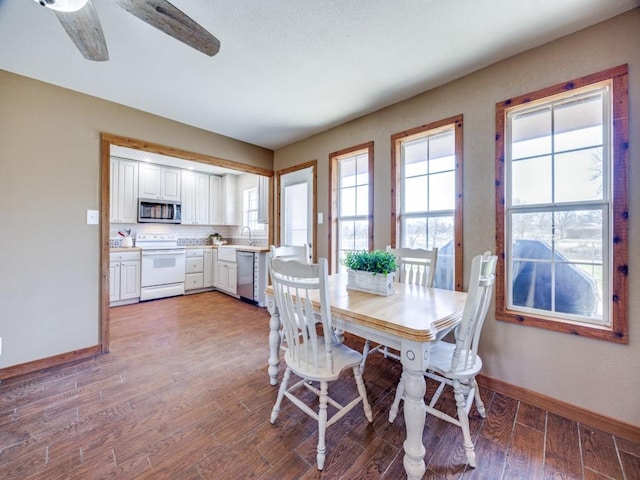 dining space with a ceiling fan, light wood-style floors, and baseboards