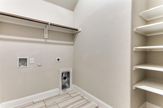 washroom featuring baseboards, gas dryer hookup, washer hookup, laundry area, and hookup for an electric dryer