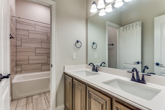 full bathroom featuring double vanity, tub / shower combination, and a sink