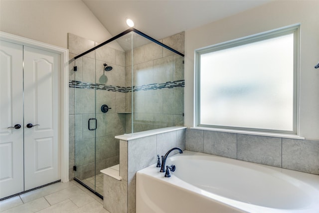 full bathroom with a garden tub, a stall shower, vaulted ceiling, and tile patterned flooring