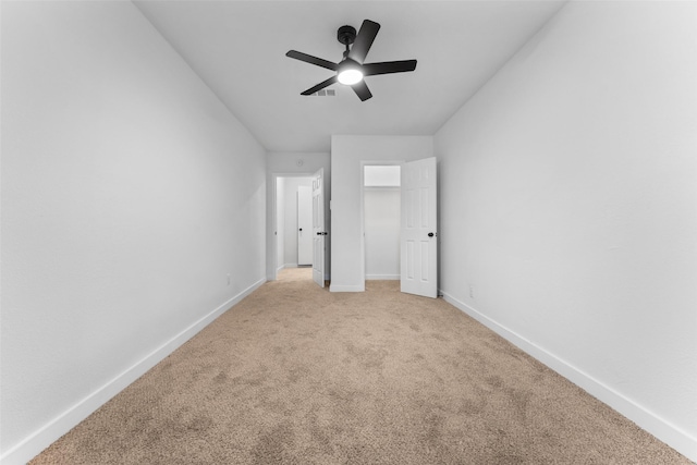 unfurnished bedroom with light carpet, visible vents, ceiling fan, and baseboards