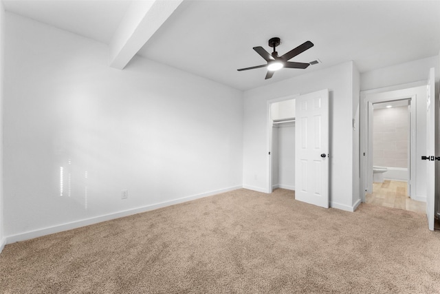 unfurnished bedroom featuring baseboards, ceiling fan, a closet, light carpet, and beamed ceiling