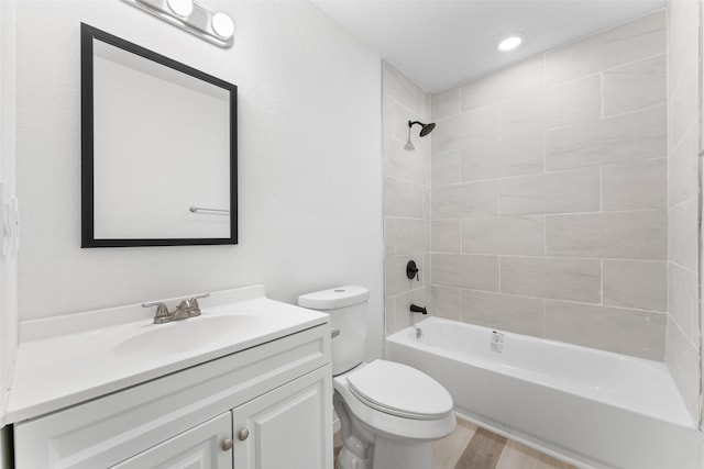 bathroom with toilet, vanity, shower / bathing tub combination, and wood finished floors