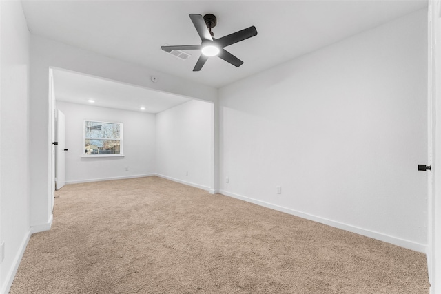 spare room featuring visible vents, a ceiling fan, recessed lighting, baseboards, and light colored carpet