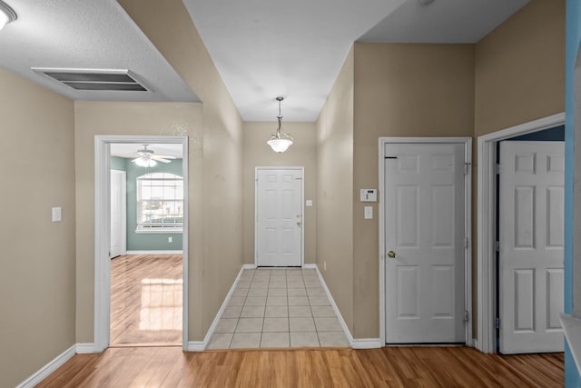 entrance foyer with visible vents, baseboards, and light wood finished floors