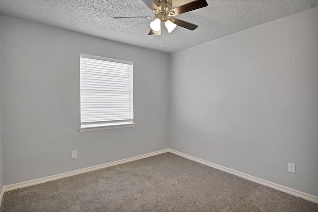 empty room with ceiling fan, carpet, baseboards, and a textured ceiling