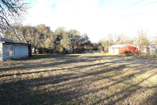 view of yard with an outdoor structure and fence