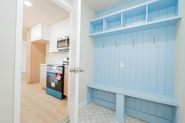 mudroom with light wood-style flooring