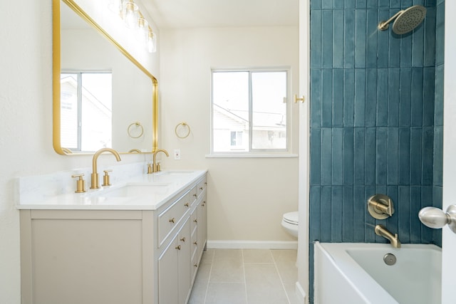 bathroom featuring tile patterned floors, double vanity, baseboards, and a sink