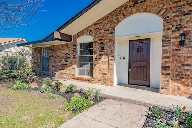 doorway to property with brick siding