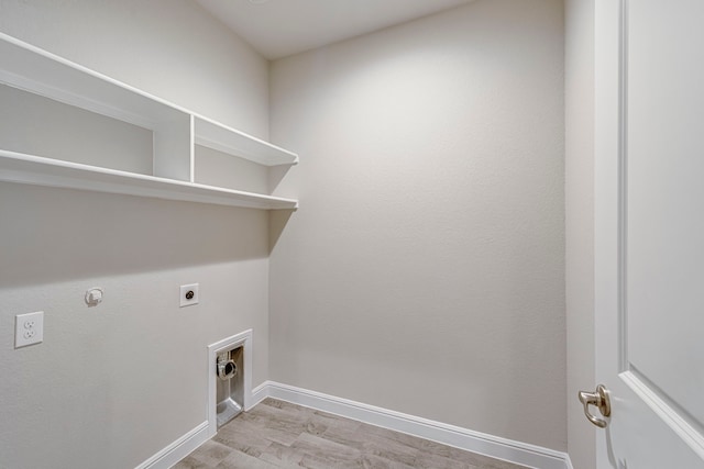 clothes washing area featuring electric dryer hookup, baseboards, gas dryer hookup, and laundry area