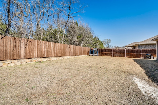 view of yard with a fenced backyard