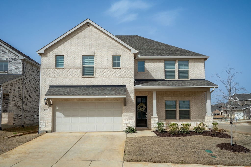 view of front facade with brick siding, roof with shingles, concrete driveway, and an attached garage