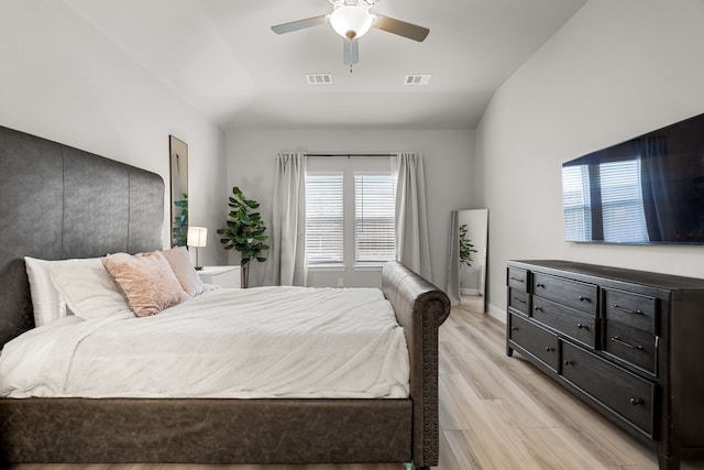 bedroom with visible vents, a ceiling fan, light wood-type flooring, and lofted ceiling