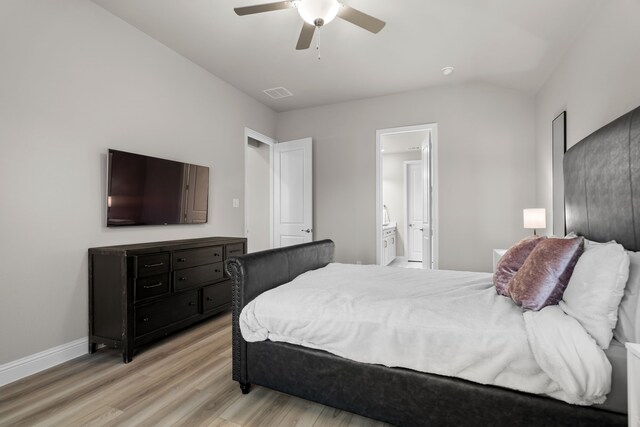 bedroom featuring a ceiling fan, baseboards, visible vents, light wood finished floors, and ensuite bathroom