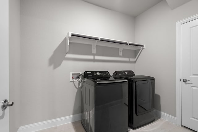 laundry room featuring washer and dryer, baseboards, and laundry area