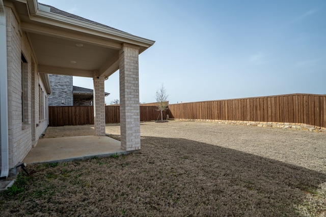 view of yard featuring a patio area and a fenced backyard