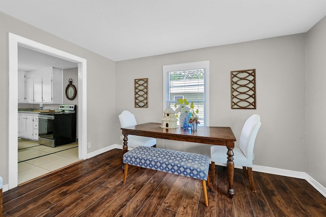 dining area featuring light wood-style flooring and baseboards