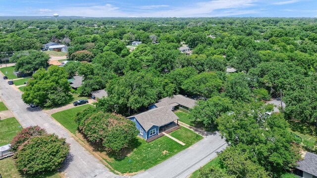 drone / aerial view featuring a forest view