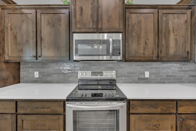 kitchen with backsplash, appliances with stainless steel finishes, and light countertops