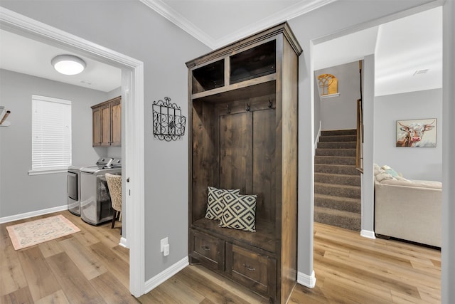 mudroom with washing machine and clothes dryer, light wood-style flooring, and crown molding