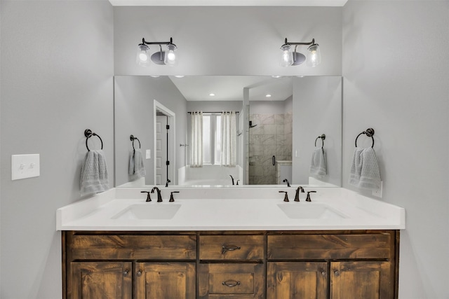 bathroom with a sink, double vanity, and a shower stall