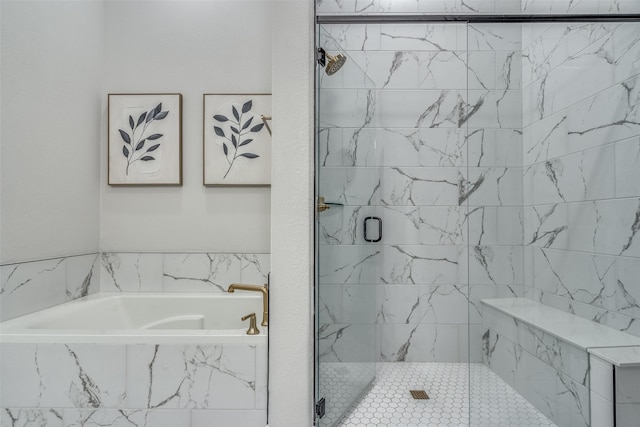 bathroom featuring a shower stall and a bath