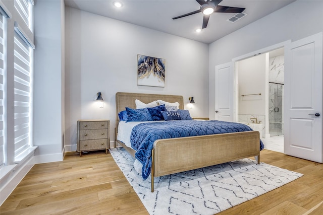 bedroom with recessed lighting, visible vents, connected bathroom, and light wood-type flooring