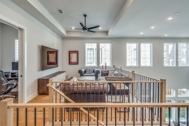 living area with a ceiling fan, visible vents, baseboards, light wood-style flooring, and recessed lighting