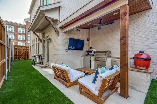 view of patio / terrace featuring a ceiling fan, an outdoor living space, area for grilling, exterior kitchen, and a fenced backyard