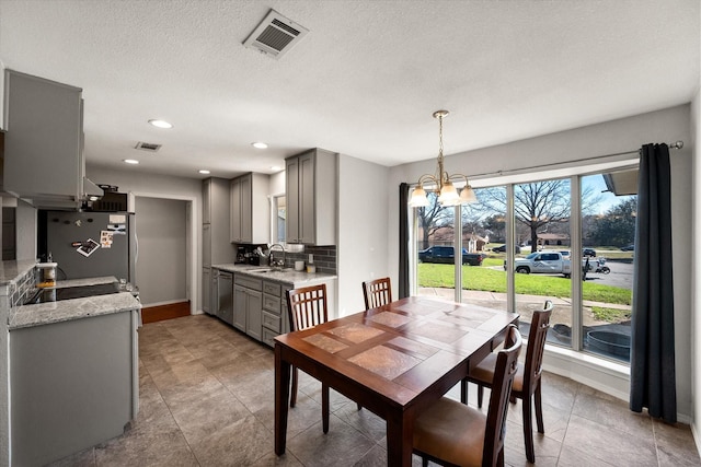 dining area featuring baseboards, visible vents, recessed lighting, a textured ceiling, and a chandelier