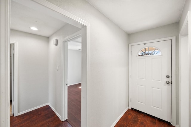 entryway featuring dark wood-style floors and baseboards