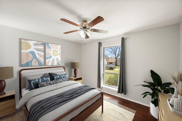 bedroom featuring a ceiling fan, wood finished floors, and baseboards