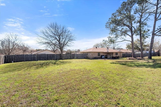 view of yard with a fenced backyard