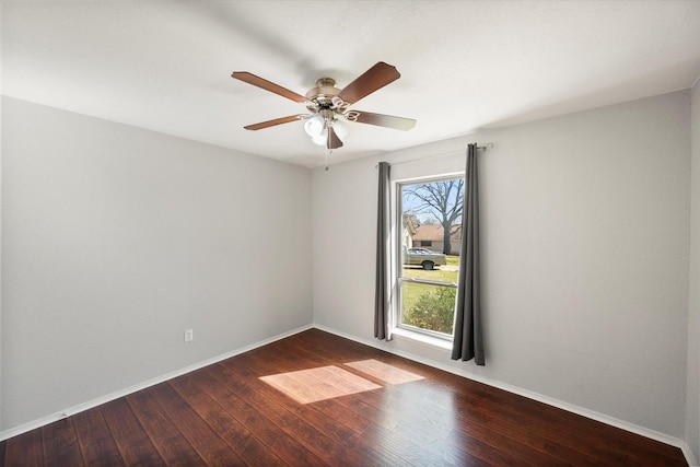 empty room featuring a ceiling fan, baseboards, and hardwood / wood-style floors