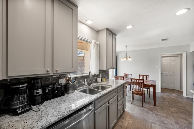 kitchen with visible vents, gray cabinetry, a sink, decorative backsplash, and dishwasher