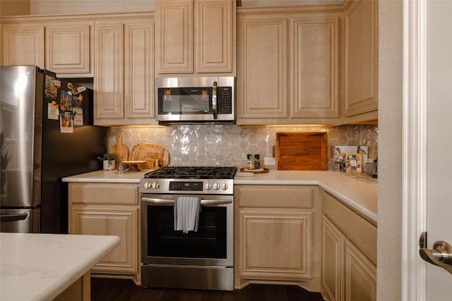 kitchen featuring light countertops, backsplash, and stainless steel appliances