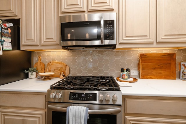 kitchen with stainless steel appliances, tasteful backsplash, and light countertops