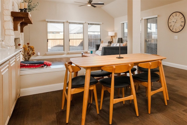 dining room featuring vaulted ceiling, dark wood-style floors, baseboards, and ceiling fan