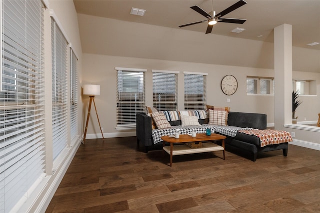 living area with visible vents, baseboards, and wood finished floors