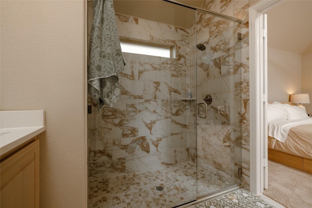 bathroom featuring vanity, a marble finish shower, and ensuite bathroom