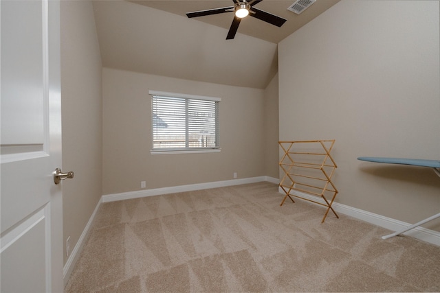 carpeted empty room with visible vents, ceiling fan, baseboards, and lofted ceiling