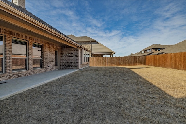 view of yard with a patio area and a fenced backyard