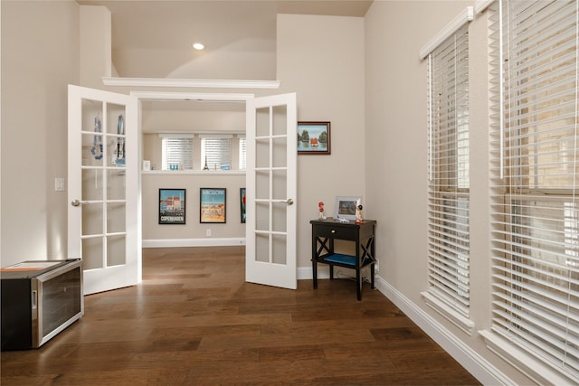 interior space with recessed lighting, french doors, baseboards, and dark wood-type flooring