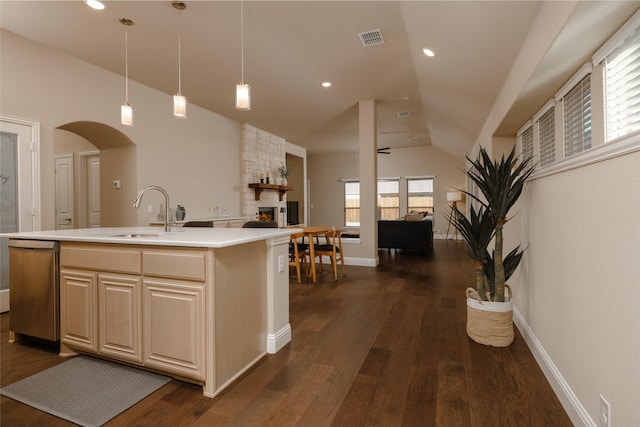 kitchen featuring dark wood-type flooring, light countertops, open floor plan, and a sink