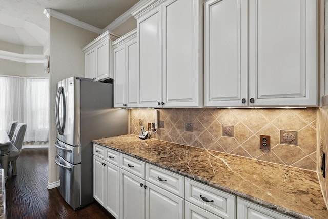 kitchen featuring tasteful backsplash, white cabinets, and crown molding