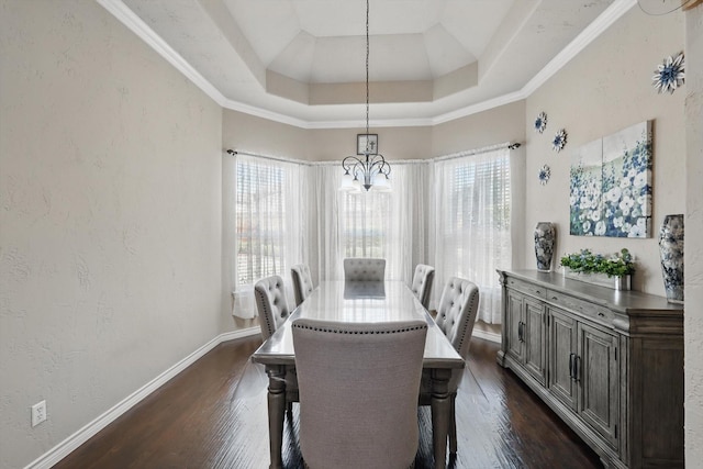 dining area featuring baseboards, a raised ceiling, dark wood-type flooring, and a notable chandelier